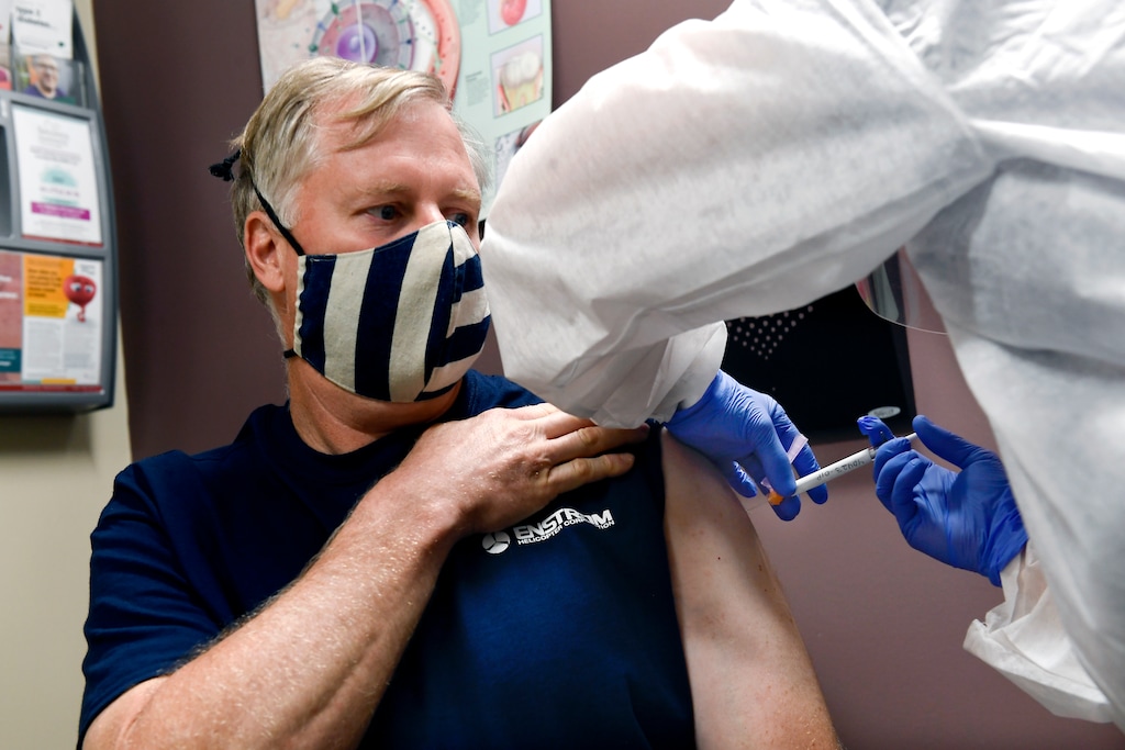 (Hans Pennink | AP) Nurse Carolyn Grausgruber gives volunteer Ithaca firefighter Wade Bardo, of Erin, N.Y., an injection as the world's biggest study of a possible COVID-19 vaccine, developed by the National Institutes of Health and Moderna Inc., gets underway Monday, July 27, 2020, in Binghamton, N.Y.