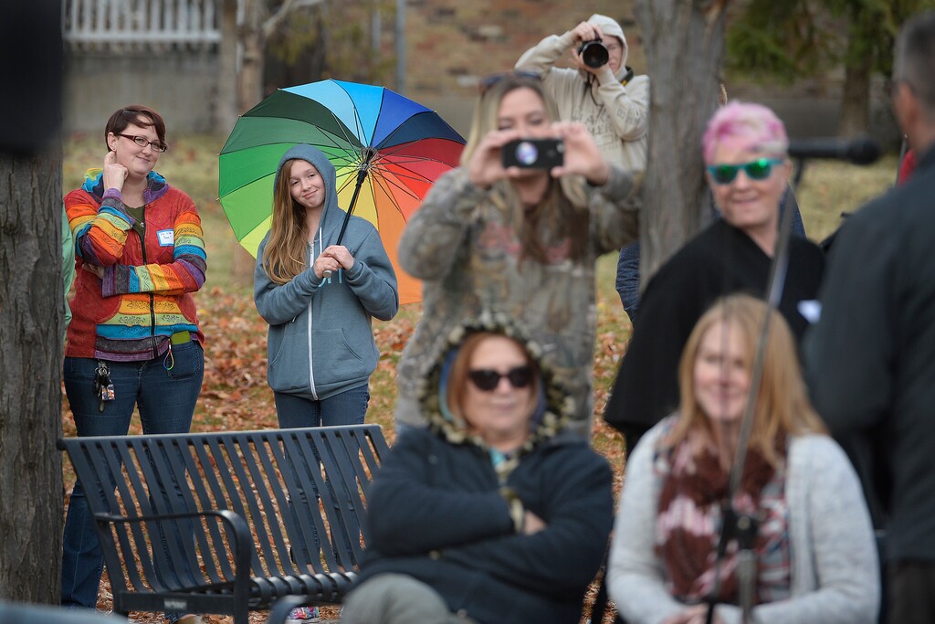 (Scott Sommerdorf   |  The Salt Lake Tribune) Under her multi-colored umbrella, Savannah - a 13 old girl who became well known after a video of her speaking to her congregation about being gay and then having the microphone switched off by church leaders - listens as Mike Norton speaks about her during the 8th annual mass resignation in City Creek Park, Sunday, November 5, 2017.