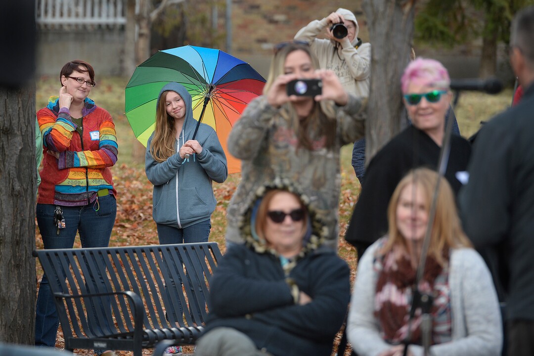 (Scott Sommerdorf   |  The Salt Lake Tribune)   
Under her multi-colored umbrella, Savannah - a 13 old girl who became well known after a video of her speaking to her congregation about being gay and then having the microphone switched off by church leaders - listens as Mike Norton speaks about her during the 8th annual mass resignation in City Creek Park, Sunday, November 5, 2017.