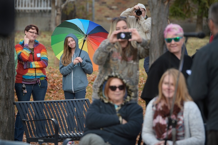(Scott Sommerdorf   |  The Salt Lake Tribune)   
Under her multi-colored umbrella, Savannah - a 13 old girl who became well known after a video of her speaking to her congregation about being gay and then having the microphone switched off by church leaders - listens as Mike Norton speaks about her during the 8th annual mass resignation in City Creek Park, Sunday, November 5, 2017.