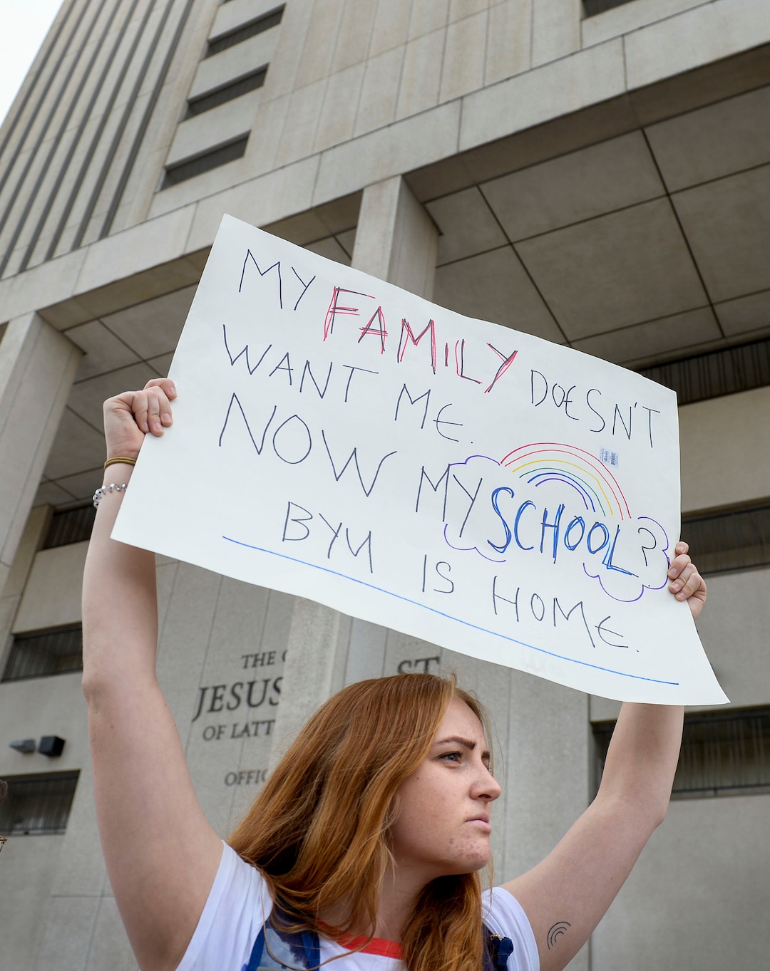 (Leah Hogsten  |  The Salt Lake Tribune) BYU student Caroline McKenzie rallies with hundreds of other students and supporters Friday.  Brigham Young University LGBTQ students took their concerns about the schoolÕs policy reversal regarding romantic behavior by same-sex couples to The Church of Jesus Christ of Latter-day Saints office building, Mar. 6, 2020. Despite removing the section on Òhomosexual behaviorÓ from BYU Honor Code last month, The LDS Church has clarified for the first time that same-sex romantic behavior is still Ònot compatibleÓ with the rules at BYU.
