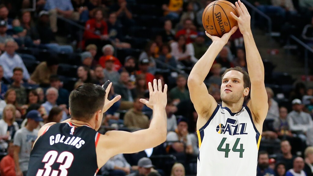 Utah Jazz forward Bojan Bogdanovic (44) shoots as Portland Trail Blazers forward Zach Collins (33) defends during the first half of a preseason NBA basketball game Wednesday, Oct. 16, 2019, in Salt Lake City. (AP Photo/Rick Bowmer)