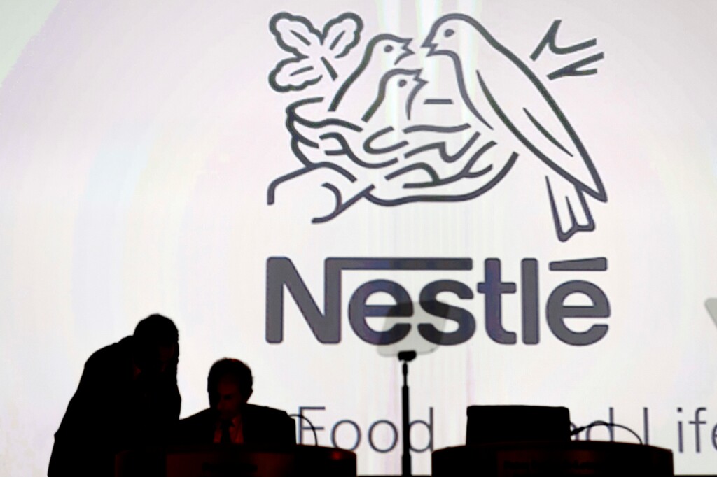 FILE - In this April 7, 2016, file photo Nestle's directors speak in front of the Nestle's logo during the general meeting of Nestle Group, in Lausanne, Switzerland.(Laurent Gillieron/Keystone via AP, File)