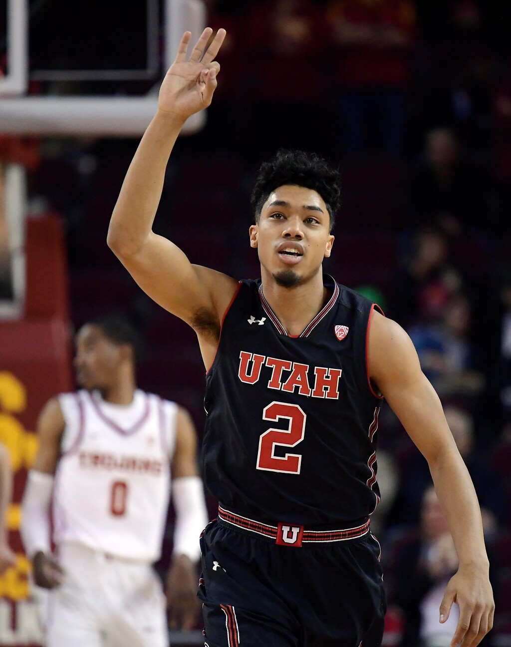Utah guard Sedrick Barefield, right, gestures after hitting a 3-point shot as Southern California guard Shaqquan Aaron stands in the background during the first half of an NCAA college basketball game Wednesday, Feb. 6, 2019, in Los Angeles. (AP Photo/Mark J. Terrill)