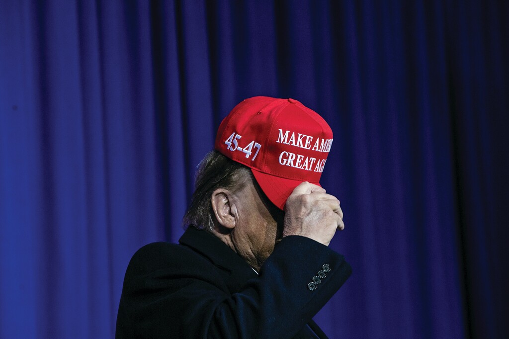 Former President Donald Trump tips his hat to the crowd at a campaign rally in Waterford, Mich., Feb. 17, 2024. (Emily Elconin/The New York Times)