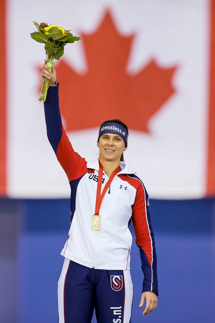 Brittany Bowe, of the United States, waves atop the podium after skating to a new world record of 1 minute, 51:59 seconds during the women's 1,500 meters at the World Cup speedskating event in Calgary, Alberta, Sunday, Nov. 15, 2015. (Lyle Aspinall/The Canadian Press via AP)