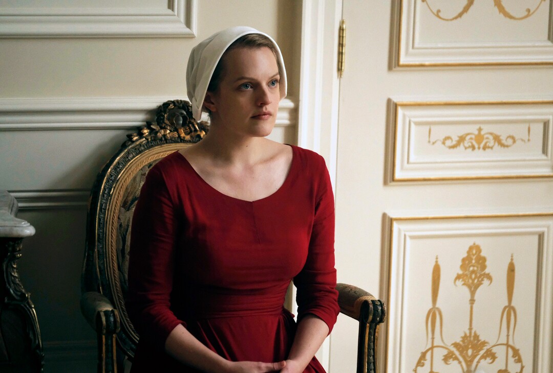 This image released by Hulu shows Elisabeth Moss as Offred in a scene from, "The Handmaid's Tale."  Moss was nominated for a Golden Globe award for best actress in a drama series or motion picture made for TV on Monday, Dec. 11, 2017. The 75th Golden Globe Awards will be held on Sunday, Jan. 7, 2018 on NBC. (George Kraychyk/Hulu via AP)