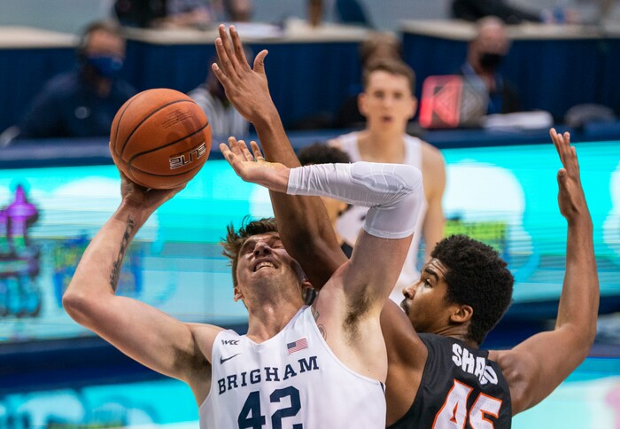 (Rick Egan | The Salt Lake Tribune) Brigham Young Cougars center Richard Harward (42) shoots, as Pacific Tigers forward Nigel Shadd (45) defends, in basketball action at the Marriott Center in Provo, on Saturday, Jan. 30, 2021.