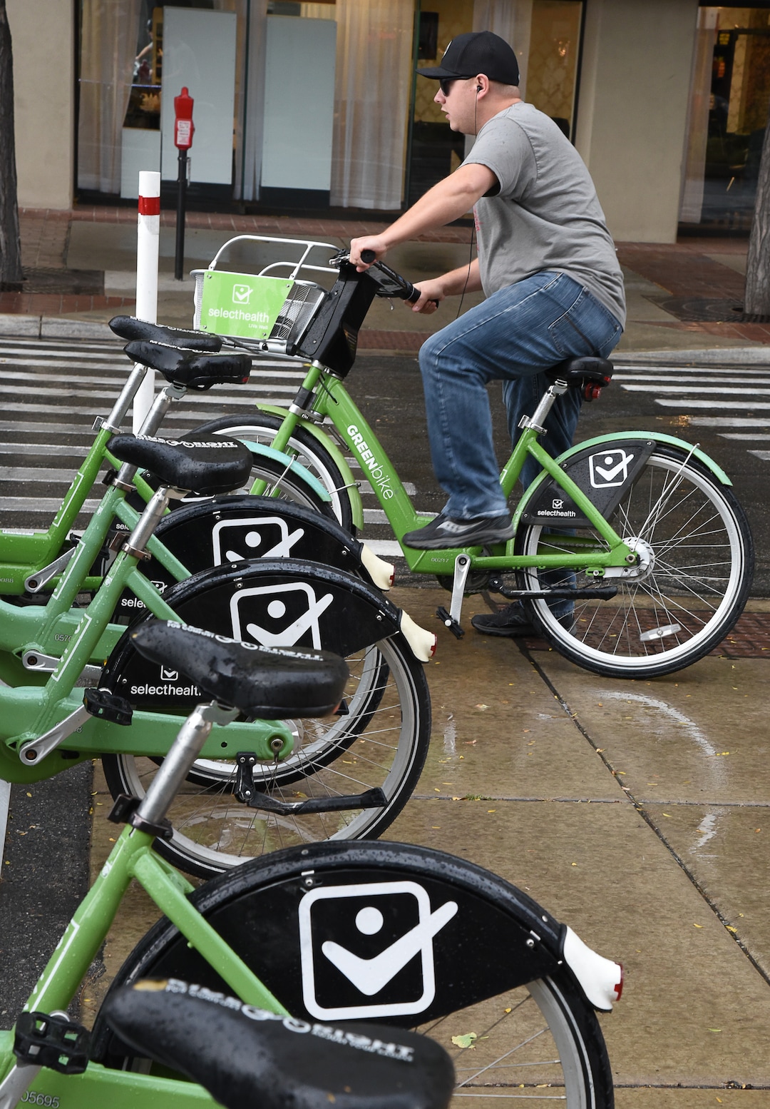 (Francisco Kjolseth  |  The Salt Lake Tribune)  A GreenBike rider tries to beat the rain on Tuesday, Oct. 2, 2108. GreenBike was on track to have their best year yet but then Lime and Bird scooters derailed their momentum.