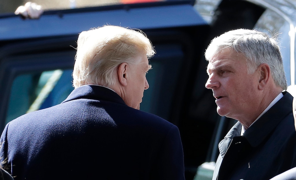 FILE - In a Friday, March 2, 2018 file photo, President Donald Trump speaks with Pastor Franklin Graham after a funeral service at the Billy Graham Library for the Rev. Billy Graham, who died last week at age 99, in Charlotte, N.C. Graham has flipped an anti-Donald Trump slogan into a T-shirt that urges his followers to pray for the 45th president. The Rev. Franklin Graham says on Facebook he was inspired to sell the “PRAY FOR 45” shirts after seeing news coverage of shirts with the slogan “IMPEACH 45.” Echoing Trump’s signature campaign motto, Graham writes: “Prayer can make America great!” (AP Photo/Chuck Burton, File)