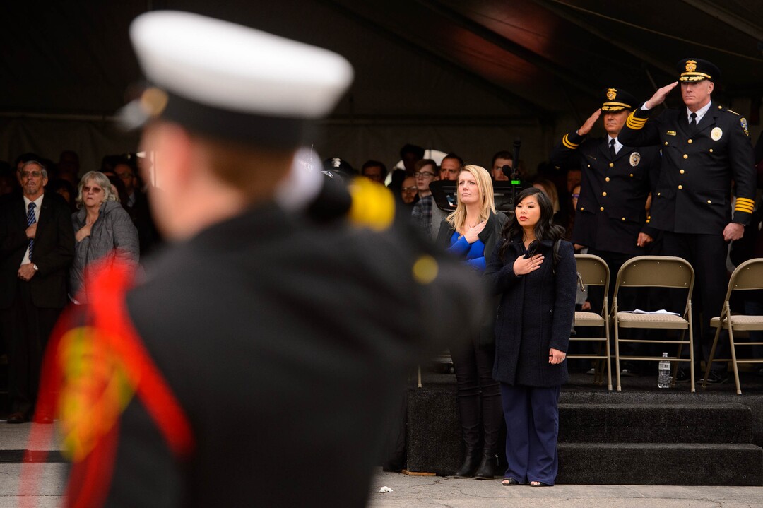 (Trent Nelson  |  The Salt Lake Tribune) Family and police stand at attention for a Flag Raising Ceremony at the dedication ceremony of the David P. Romrell Public Safety Building on Sunday Nov. 24, 2019. The building is named after Officer Romrell, who was killed in the line of duty on Nov. 24, 2018 - one year ago.
