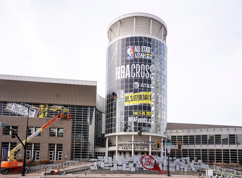 (Rick Egan | The Salt Lake Tribune) Workers past banners on the Salt Palace for All-Star Weekend, on Saturday, Feb. 11, 2023.