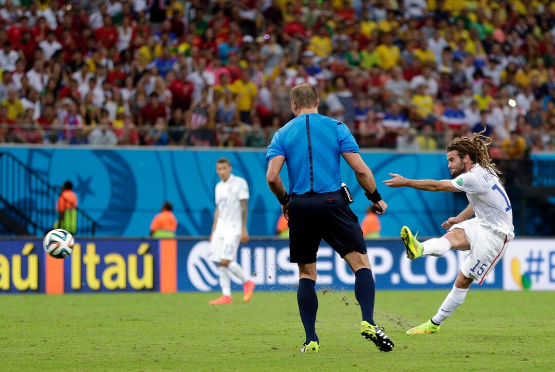 Referee Nestor Pitana from Argentina watches as United States' Kyle Beckerman shoots during the group G World Cup soccer match between the United States and Portugal at the Arena da Amazonia in Manaus, Brazil, Sunday, June 22, 2014. (AP Photo/Julio Cortez)