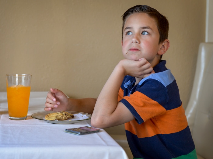 (Leah Hogsten  |  The Salt Lake Tribune)  "We come here every haircut day," said Christian Buie, 8, while eating his chocolate chip cookie with his father at Auntie Rae's Dessert Island in Holladay.
