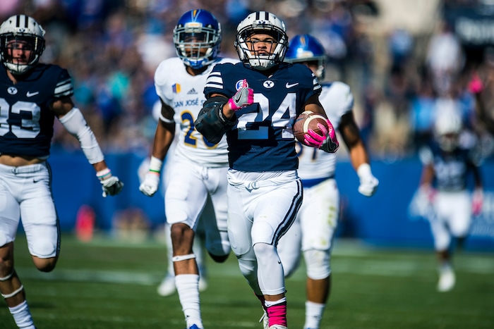 (Chris Detrick  |  The Salt Lake Tribune)  Brigham Young Cougars running back KJ Hall (24) scores a 75-yard touchdown past San Jose State Spartans cornerback Tre Webb (26) and San Jose State Spartans safety Ethan Aguayo (31) during the game at LaVell Edwards Stadium Saturday, October 28, 2017.  