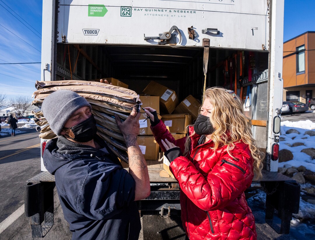 (Rick Egan | The Salt Lake Tribune) Carin Crowe, from Habitat for Humanity, and Georgia, a volunteer with Black Lives for Humanity, distribute wool blankets donated by the Sikh community to people in camps in Salt Lake City to help the unsheltered stay warm Thursday, Dec. 23, 2021.