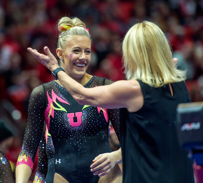 (Rick Egan  |  The Salt Lake Tribune)  MaKenna Merrell-Giles gets a hug from coach Megan Marsden, after finishing her routine on the beam, in PAC-12 Gymnastics action between the Utes and The California Golden Bears, in the Jon M. Huntsman Center, in Salt Lake City, Saturday, Feb. 9, 2019. Merrell  -Giles won the All-round for the Utes.