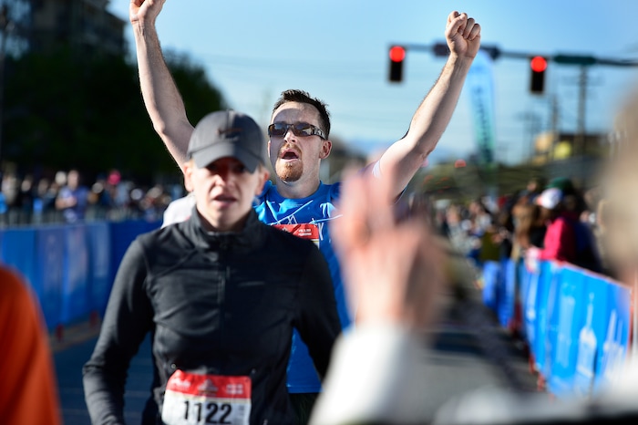 (Scott Sommerdorf | The Salt Lake Tribune)An exhausted runner crosses the finish line in the Salt Lake City half marathon, Saturday, April 21, 2018.