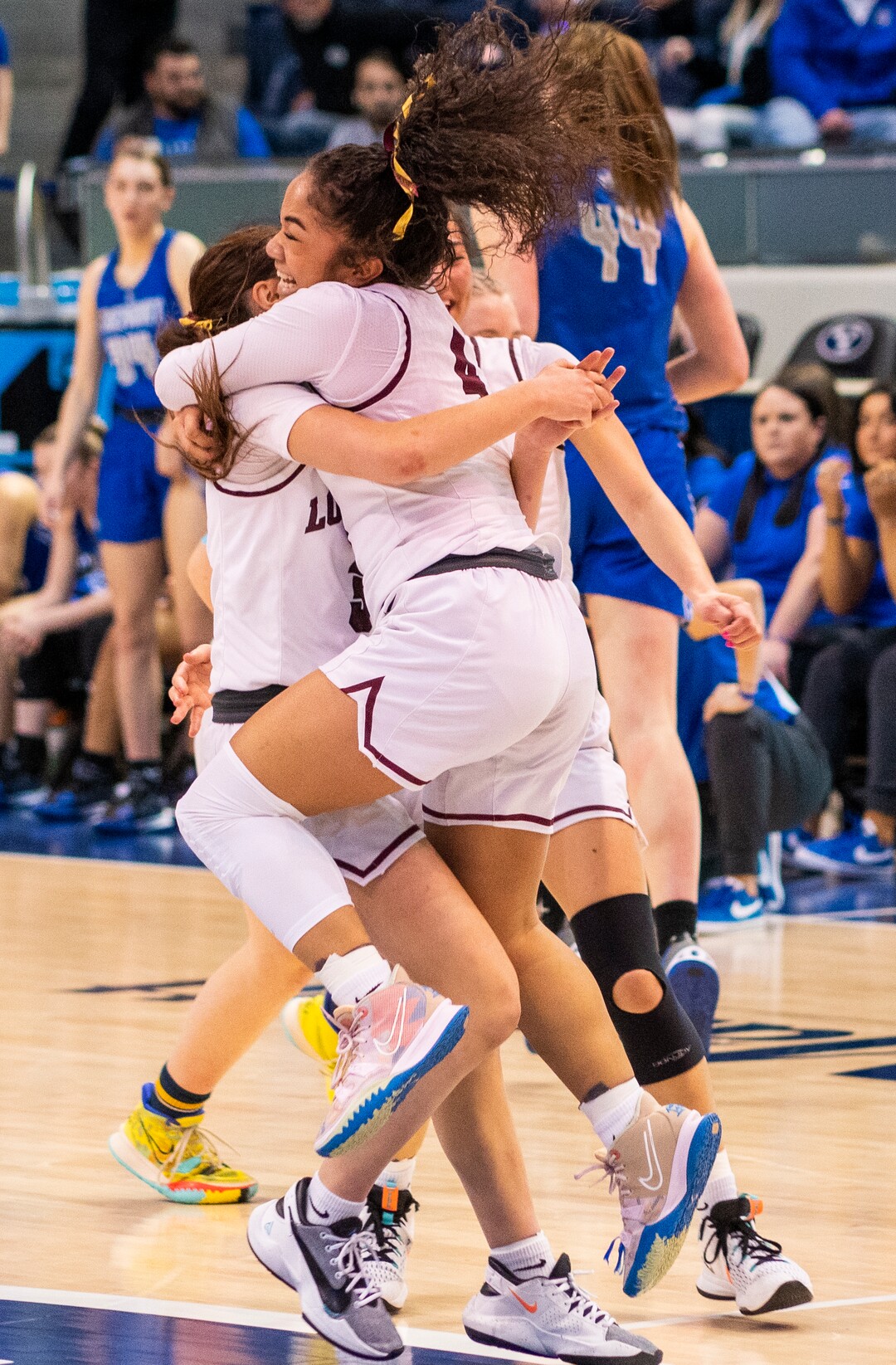 (Rick Egan | The Salt Lake Tribune) Lone Peak guard Makeili Ika leaps in to the arms of her team mates as they celebrates their 67-65 double-overtime win over Fremont, in the 6A State Championship game, at the Marriott Center in Provo, on Saturday, March 5, 2022.  Ika, hit the winning shot with .5 seconds left on the clock. 