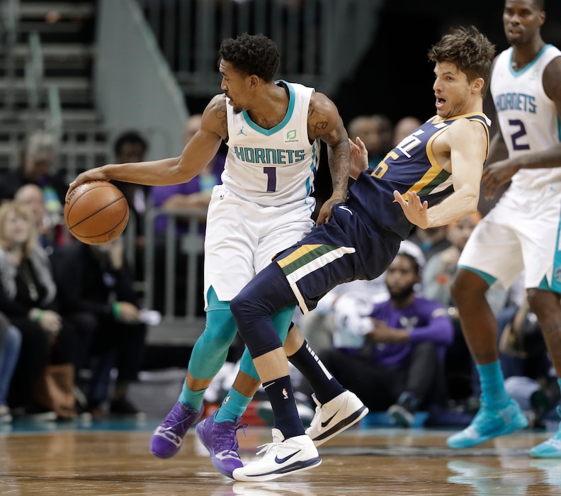 Charlotte Hornets' Malik Monk (1) runs into Utah Jazz's Kyle Korver (26) during the first half of an NBA basketball game in Charlotte, N.C., Friday, Nov. 30, 2018. (AP Photo/Chuck Burton)