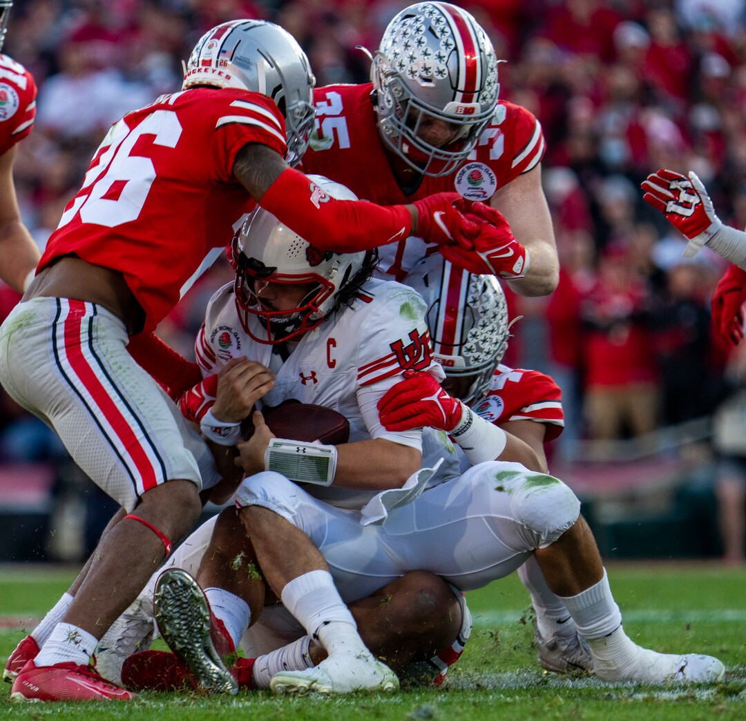 (Rick Egan | The Salt Lake Tribune)   Utah Utes quarterback Cameron Rising (7), is tackled by Ohio State Buckeyes cornerback Cameron Brown (26) and Ohio State Buckeyes linebacker Tommy Eichenberg (35) in football action between Utah Utes and Ohio State Buckeyes in the Rose Bowl in Pasadena, CA, on Saturday, January 1, 2022.