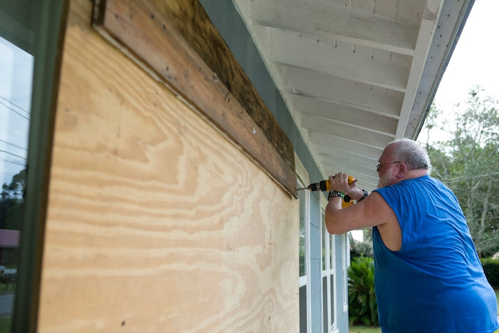(Joshua Boucher | News Herald | The Associated Press) David Hayes boards up a window at this home in Panama City, Fla., as Hurricane Michael approaches on Tuesday, Oct. 9, 2018.