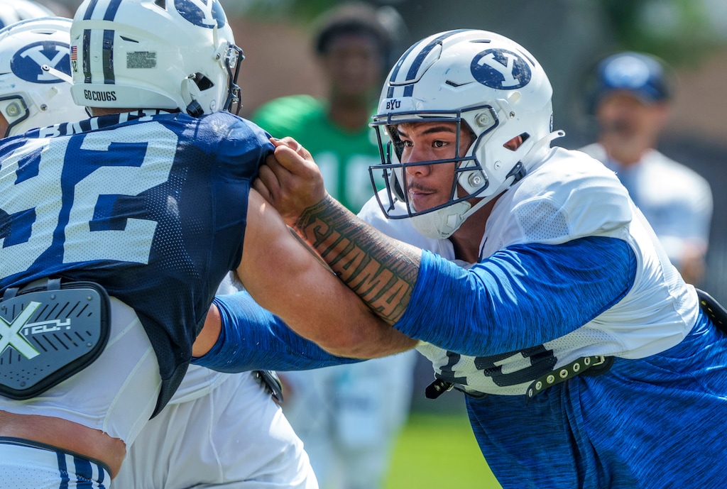 (Leah Hogsten | The Salt Lake Tribune) Brigham Young University offensive lineman Kingsley Suamataia makes a block during football practice Aug. 8, 2023 in Provo. 