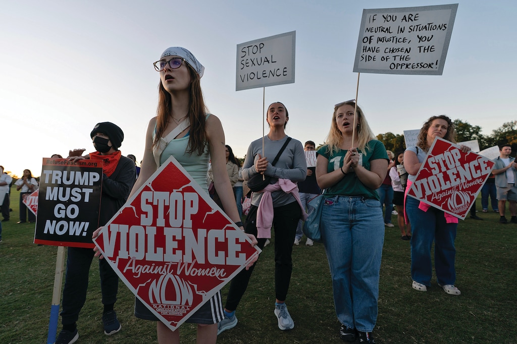Demonstrators rally during a "Stop Sexual Violence" protest at the Washington Monument, Thursday, Oct. 8, 2026, in Washington. (AP Photo/Jose Luis Magana)