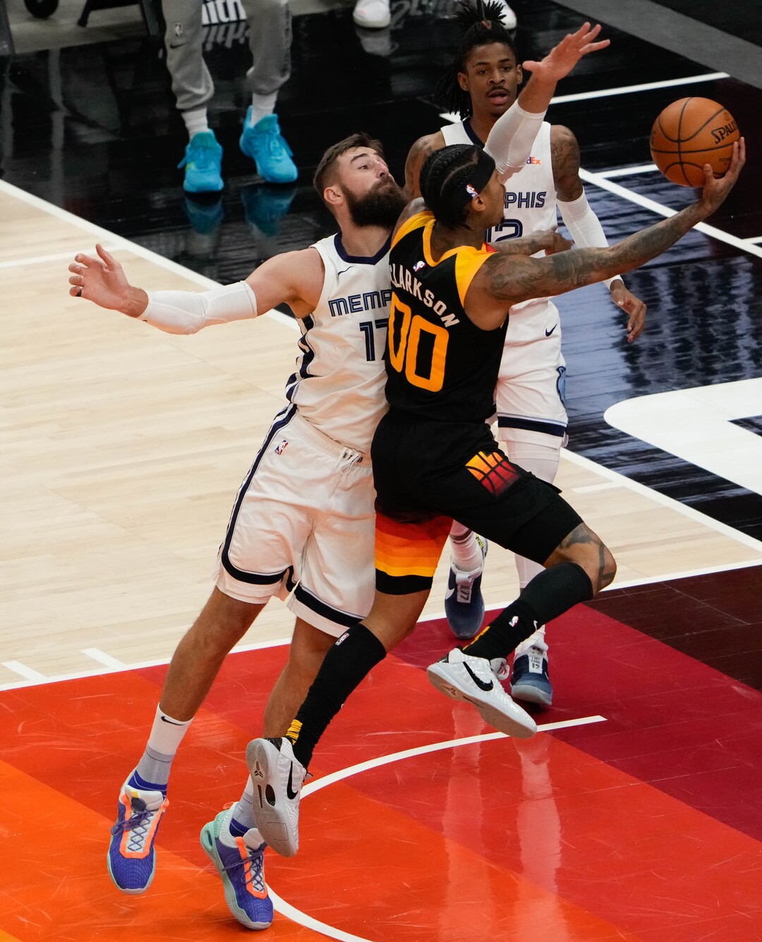 (Francisco Kjolseth | The Salt Lake Tribune) Utah Jazz guard Jordan Clarkson (00) lays one up past Memphis Grizzlies center Jonas Valanciunas (17) in the first half of Game 5 of an NBA basketball first-round playoff series Wednesday, June 2, 2021, in Salt Lake City, UT.