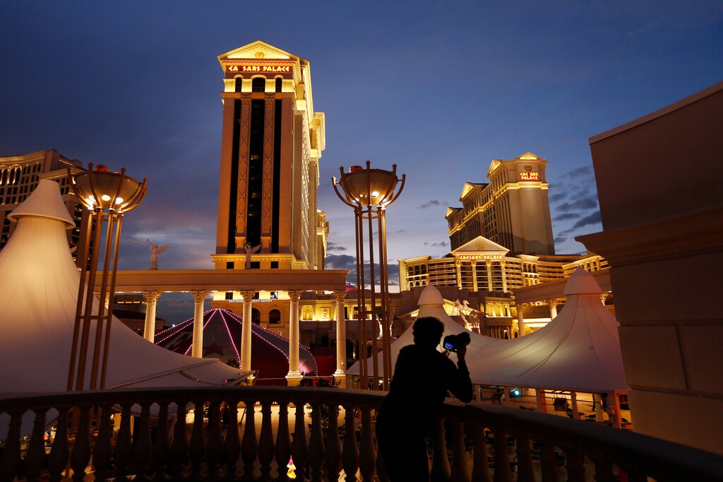 (John Locher | AP Photo) In this Monday, Jan. 12, 2015, file photo, a man takes pictures of Caesars Palace hotel and casino, in Las Vegas.