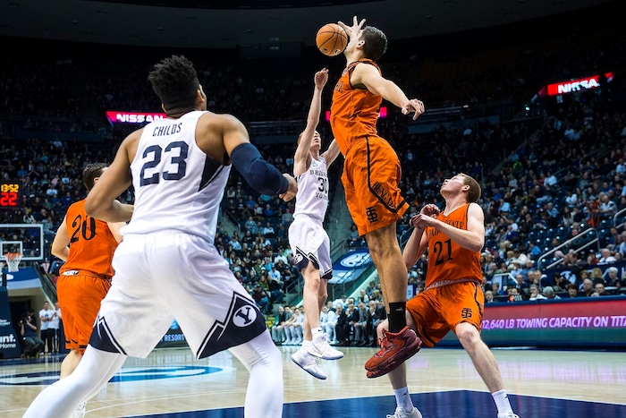 (Chris Detrick  |  The Salt Lake Tribune)  Brigham Young Cougars guard TJ Haws (30) shoots past Idaho State Bengals center Novak Topalovic (13) and Idaho State Bengals guard Jared Stutzman (21) during the game at the Marriott Center Thursday, December 21, 2017.  
