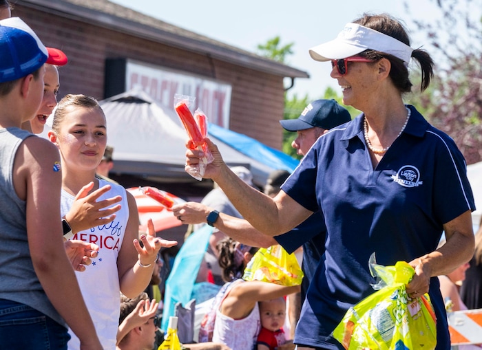 (Rick Egan | The Salt Lake Tribune) Layton Mayor Joy Petro hands out free popsicles on the parade route, before the Layton Liberty Days parade, on Monday, July 5, 2021.