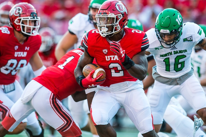 (Chris Detrick  |  The Salt Lake Tribune)  Utah Utes running back Zack Moss (2) runs past North Dakota Fighting Hawks defensive back Torrey Hunt (16) during the game at Rice-Eccles Stadium Thursday, August 31, 2017. Utah Utes are leading North Dakota Fighting Hawks 17-9 at halftime. 