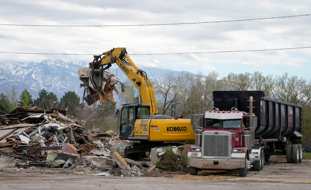 (Bethany Baker | The Salt Lake Tribune) Crews load debris from the demolished Sizzler restaurant near Sugar House Park into trailers in Salt Lake City on Wednesday, April 17, 2024.