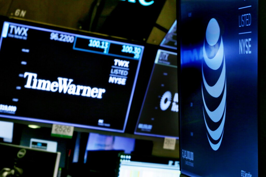 (AP Photo/Richard Drew) The logos for Time Warner and AT&T appear above alternate trading posts on the floor of the New York Stock Exchange, Wednesday, June 13, 2018. A federal judge has approved the $85 billion mega-merger of AT&T and Time Warner, potentially ushering in a wave of media consolidation while shaping how much consumers pay for streaming TV and movies.