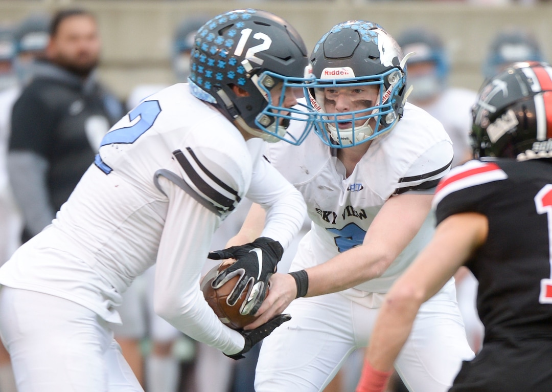 (Leah Hogsten  |  The Salt Lake Tribune) Sky ViewÕs quarterback Kason Carlsen hands off to Mason Falslev. Sky View High School defeated Park City 35-0 to win the 4A State Championship football title, Nov. 11, 2019 at Rice-Eccles Stadium.