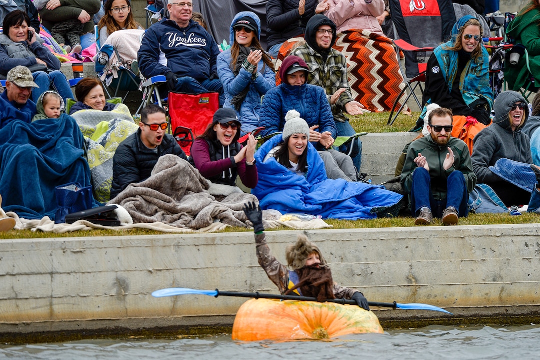 (Leah Hogsten  |  The Salt Lake Tribune) Pumpkin regatta bystanders cheer for winner Summit Urry, 9, of Bountiful during the annual Giant Pumpkin Regatta, October 19, 2019 on Oquirrh Lake in Daybreak, South Jordan.