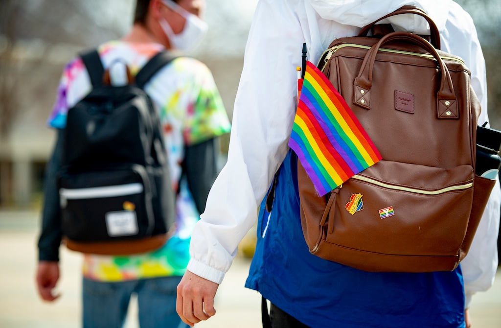 (Isaac Hale | Special to The Tribune) A Brigham Young University student sports various rainbow-colored items on his backpack in support of Rainbow Day as he walks with his friends on the campus of BYU in Provo on Thursday, March 4, 2021. A student at the school was recently called a Mormon term associated with an anti-Christ by a professor. The school has remained silent.