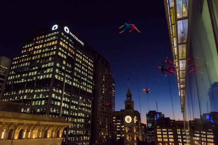 (Photo courtesy of Basil Tsimoyianis) Oakland, Calif.-based “vertical dance” company BANDALOOP performs in Sydney, Australia. They will be appearing at the Utah Arts Festival June 21-24, and will perform twice daily (5:30 and 7 p.m.) on the six-story library glass wall above the reflecting pool.