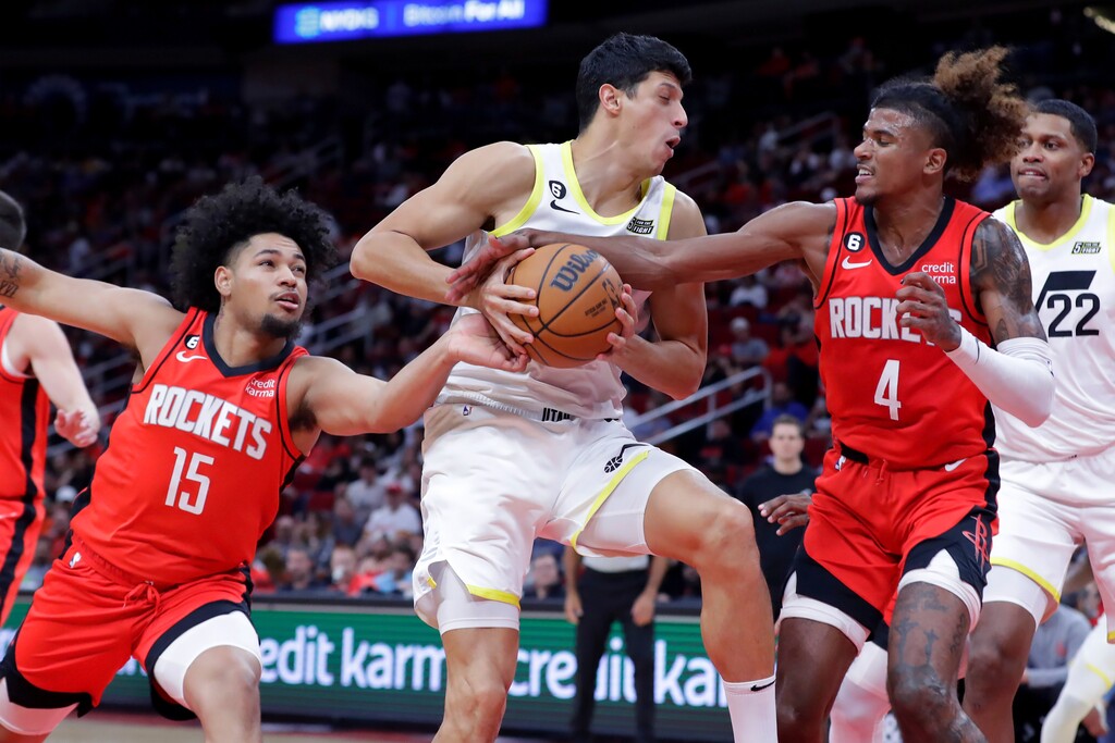 Houston Rockets guards Daishen Nix (15) and Jalen Green (4) try to strip the ball from Utah Jazz forward Simone Fontecchio, center, during the second half of an NBA basketball game Monday, Oct. 24, 2022, in Houston. (AP Photo/Michael Wyke)