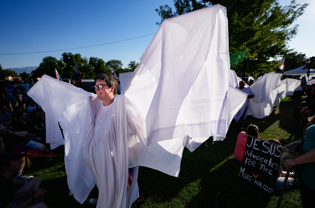 (Francisco Kjolseth | The Salt Lake Tribune) People dressed as “angels” arrive for the RaYnbow Collective’s Back to School Pride Night for BYU students at Kiwanis Park in Provo in an effort to block counterprotesters on Saturday, Sept. 3, 2022.