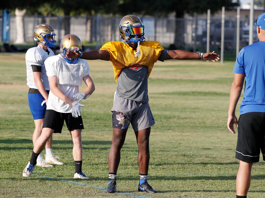 (Gary Kazanjian | Special to The Tribune) Clovis High School quarterback Nate Johnson works out with his team at Clovis High School, who committed to play for the University of Utah, shown Wednesday, July 28, 2021, in Clovis, Calif.