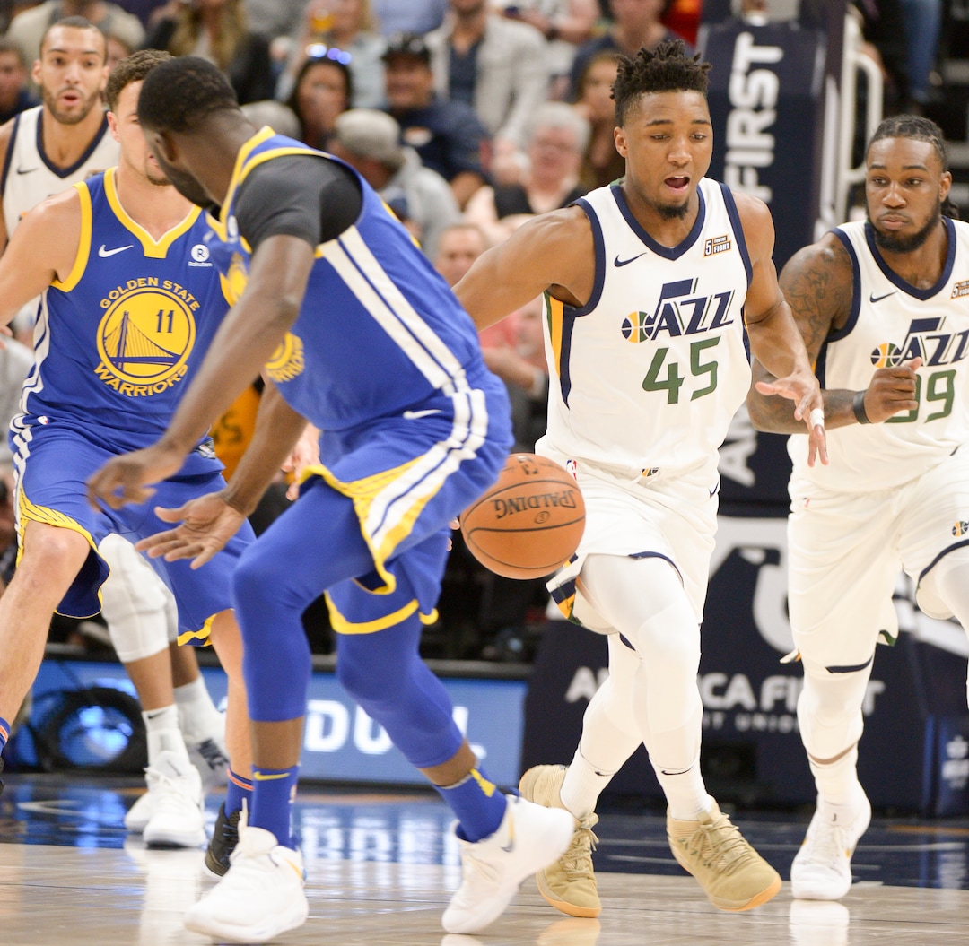 (Leah Hogsten  |  The Salt Lake Tribune)  Utah Jazz guard Donovan Mitchell (45) grabs the steal from Golden State Warriors forward Draymond Green (23).  The Utah Jazz lead the Golden State Warriors 62-33 during their game, Tuesday, April 10, 2018 at the Vivant Smart Home Arena. 