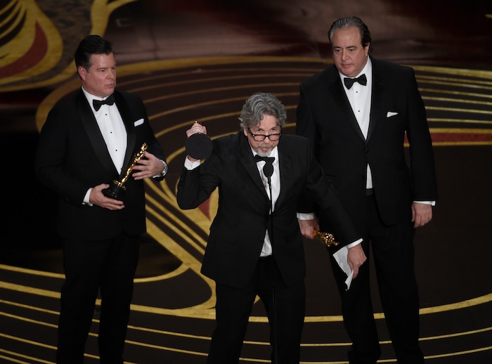Brian Hayes Currie, from left, Peter Farrelly and Nick Vallelonga accept the award for best original screenplay for "Green Book" at the Oscars on Sunday, Feb. 24, 2019, at the Dolby Theatre in Los Angeles. (Photo by Chris Pizzello/Invision/AP)
