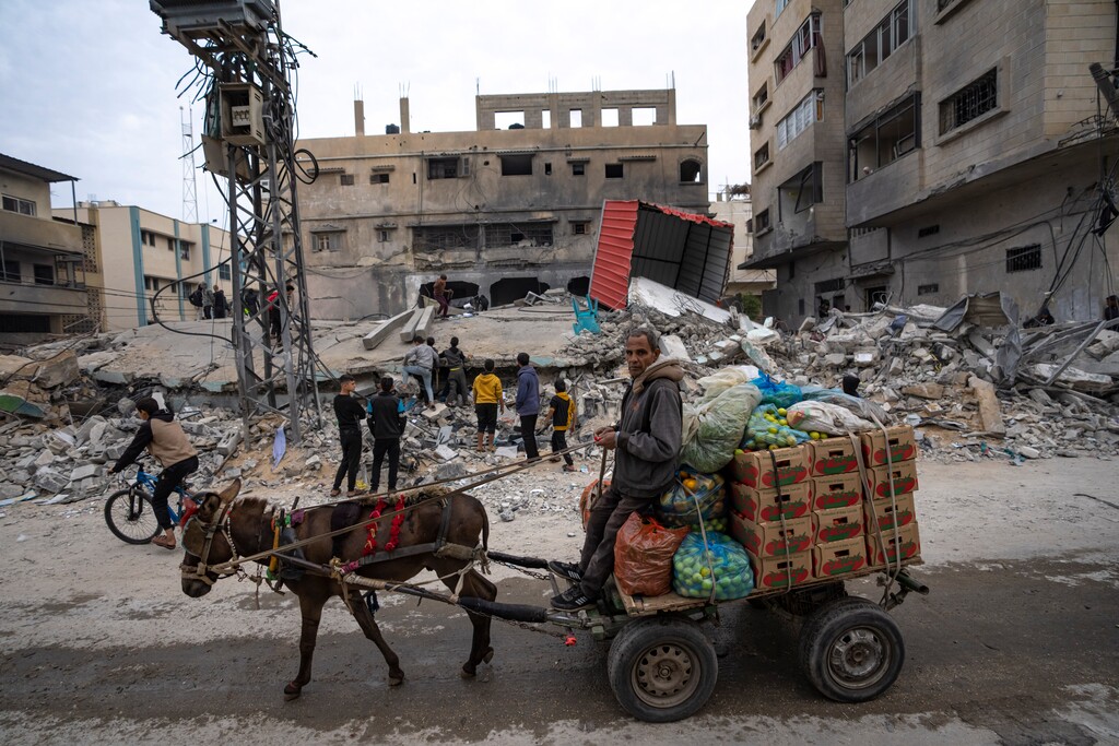 (Fatima Shbair | AP) Palestinians inspect a house after it was hit by an Israeli bombardment on Rafah, southern Gaza Strip, Thursday, Dec. 21, 2023.