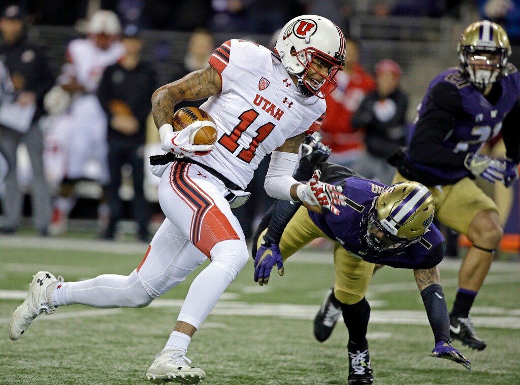 Utah's Raelon Singleton (11) runs past Washington defenders on the way to a 40-yard touchdown during the first half of an NCAA college football game Saturday, Nov. 18, 2017, in Seattle. (AP Photo/Elaine Thompson)
