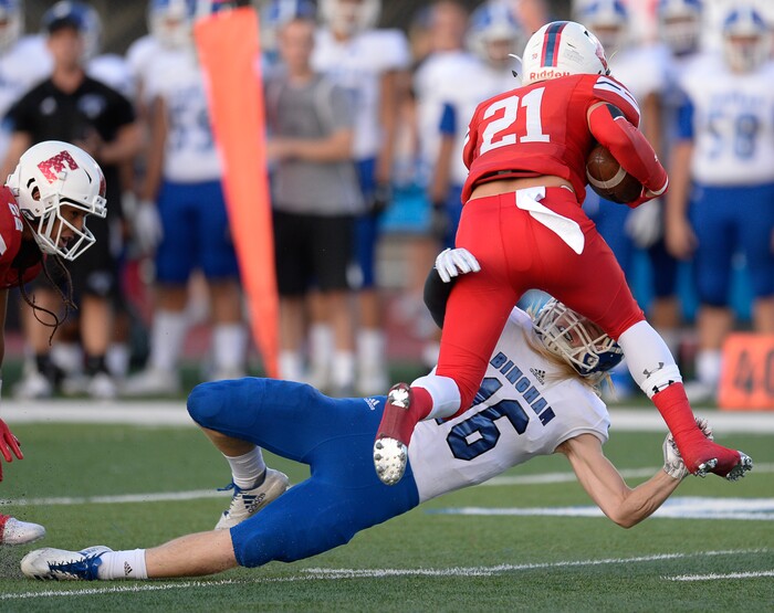 (Francisco Kjolseth  |  The Salt Lake Tribune)  Charlie Vincent of East High is taken down by Aiden Larsen of Bingham at East on Friday, Aug. 24, 2018.