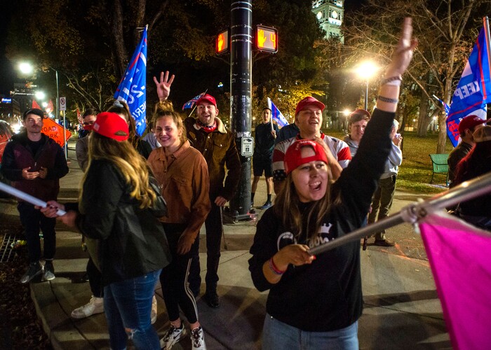 (Rick Egan | The Salt Lake Tribune)  Trump supporters, yell four more years, during a rally at Washington Square, on Monday, Nov. 2, 2020.
