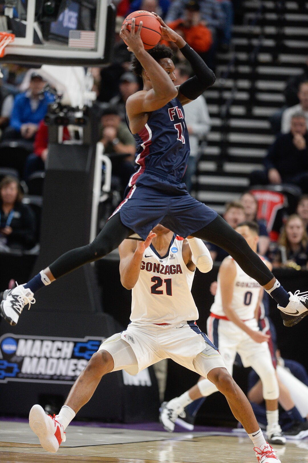 (Francisco Kjolseth  |  The Salt Lake Tribune)  Fairleigh Dickinson Knights forward Kaleb Bishop (12) regains control of the ball over Gonzaga Bulldogs forward Rui Hachimura (21) as Gonzaga faces Fairleigh Dickinson in their first round menÕs NCAA March Madness tournament game at Vivint Smart Home Arena in Salt Lake City on Thursday, March 21, 2019.