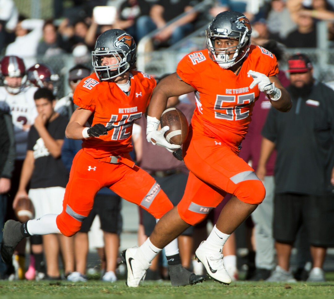 (Rick Egan  |  The Salt Lake Tribune)   Skyridge Stone Mulitalo (52) runs for a touchdown, after intercepting a Jordan pass, in prep 5A playoff action, in Lehi, Friday, Nov. 2, 2018.